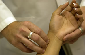 Craig taking a patient's pulse